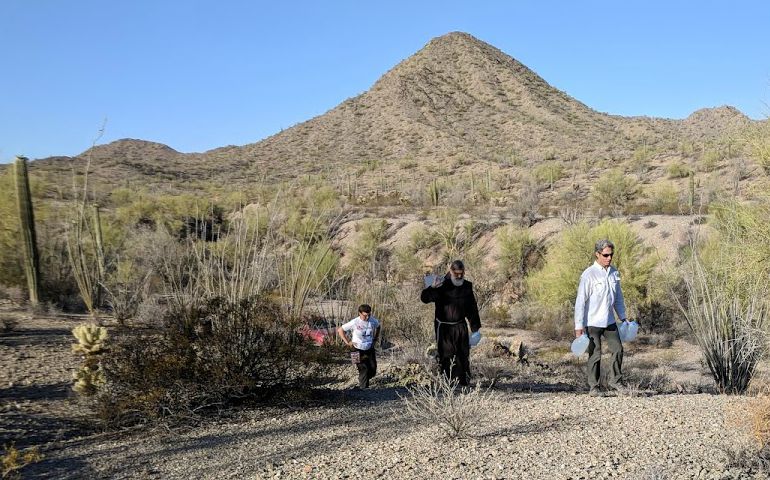 Members of the Tucson Samaritans leave gallon-jugs of water out in the desert for migrants to use. (Peter Tran)