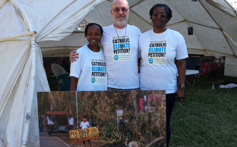 Three participants in the Global Catholic Climate Movement's 10-day fast for climate action stand outside their tent in McPherson Square in Washington D.C. From left, Anne Kirori, Patrick Carolan and Sylvia Washington. (Photo courtesy Global Catholic Climate Movement) 
