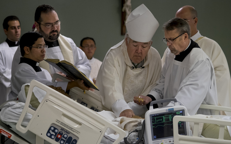 Bishop David Choby of Nashville, Tenn., anoints William Carmona's hands as part of the ordination rite Monday at Christus Santa Rosa Medical Center in San Antonio. (CNS/Rennessee Register/Rick Musacchio)