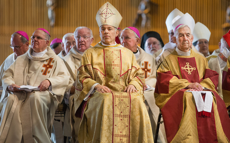 Archbishop Salvatore J. Cordileone, center, and retired Archbishop John R. Quinn of San Francisco, right, look on during Cordileone's installation Mass at the Cathedral of St. Mary of the Assumption on Thursday. He succeeds Archbishop George H. Niederauer, 76, who had headed the San Francisco Archdiocese since 2005. (CNS/Catholic San Francisco/Dennis Callahan)