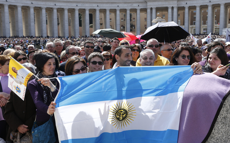 Pilgrims holds Argentina's flag in St. Peter's Square before Pope Francis' recitation of the "Regina Coeli" in 2013 at the Vatican. (CNS/Paul Haring) 