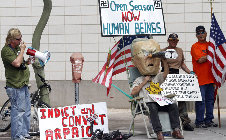 A man wears a mask of Maricopa County Sheriff Joe Arpaio during a protest against S.B. 1070, Arizona's immigration law, in 2010 outside the U.S. District Court in Phoenix. (CNS/Reuters/Joshua Lott)