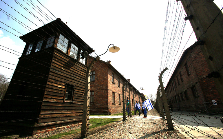 Participants in the "'March of the Living" carry Israeli flags inside the former Nazi death camp Auschwitz on April 16. (CNS/EPA/Stanislaw Rozpedzik)