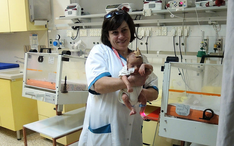 A nurse in the neonatal unit of Caritas Baby Hospital in Bethlehem holds a premature baby. Babies from across the West Bank and Gaza are transferred to the hospital, which has one of the most advanced neonatal units in the Palestinian territories. (GSR photo / Melanie Lidman)