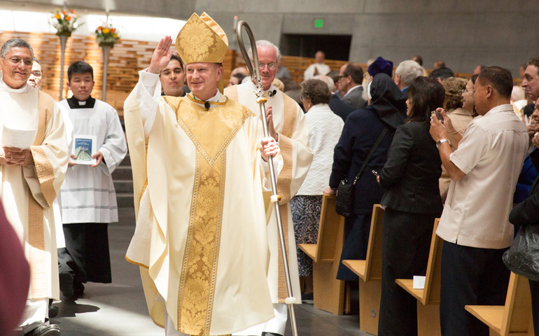 Bishop Michael Barber waves to the congregation after being installed as the fifth bishop of the diocese of Oakland, Calif., May 25 at the Cathedral of Christ the Light. (CNS/The Catholic Voice/Jose Luis Aguirre)