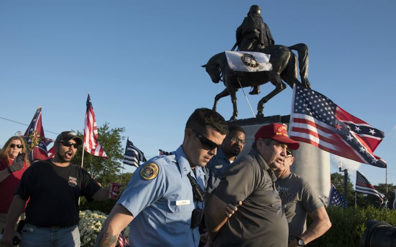 New Orleans police arrest a man after he allegedly struck a counter-demonstrator May 16 while protesting the impending removal of a statue of Confederate Gen. P.T.G. Beauregard. (Polaris/David Rae Morris)