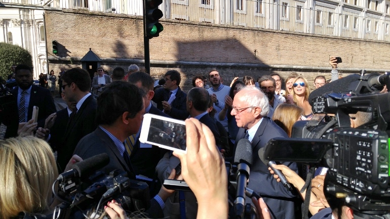 U.S. Democratic presidential candidate Bernie Sanders talks to press outside the Vatican walls after speaking at an event Friday on Pope John Paul II's 1991 encyclical 'Centesimus Annus' (NCR/Joshua J. McElwee)