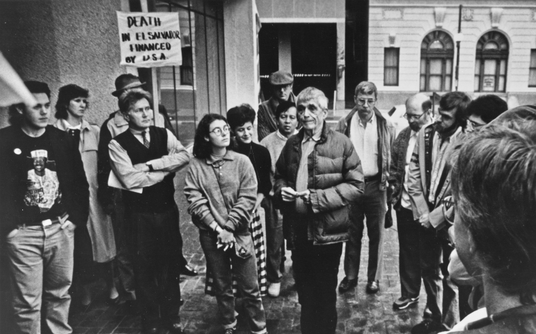 Jesuit Fr. Daniel Berrigan; center, talks to a group of supporters outside the federal courthouse in New Orleans prior to his trail for contempt of court Feb. 8, 1990. Actor Martin Sheen; second from left, testified at the trail. (CNS/Clarion Herald/Frank Methe)