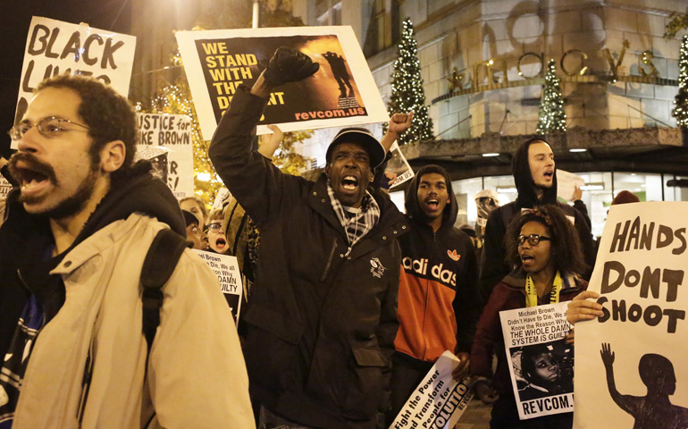 Demonstrators march through Seattle on Nov. 24, 2014, following a decision by a Missouri grand jury not to indict a white Ferguson police officer in the fatal shooting of Michael Brown. (CNS/Reuters/Jason Redmond)