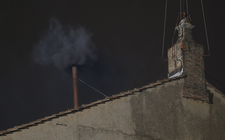 Black smoke billows from the chimney of the Sistine Chapel, the sign that cardinals did not elect a pope in their first round of balloting March 12 at the Vatican. (CNS/Paul Haring) 