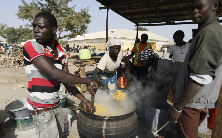 People fleeing Boko Haram violence in the northeast region of Nigeria cook food at a camp for internally displaced people Jan. 13 in Yola. (CNS/Reuters/Afolabi Sotunde)