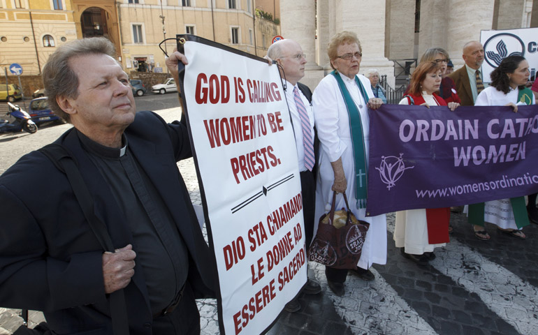 Roy Bourgeois stands with other supporters of women's ordination at the gates of St. Peter's Square during a 2011 demonstration in Rome. (CNS/Paul Haring)
