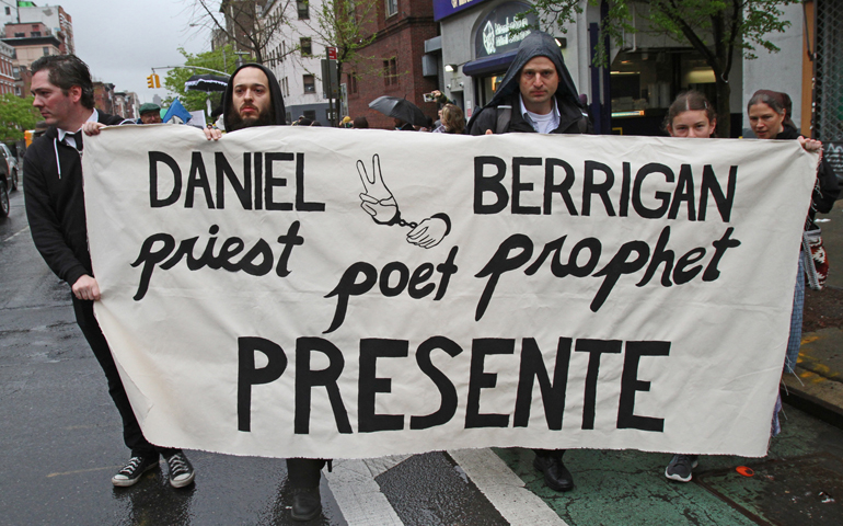 Mourners march May 6 prior to the funeral Mass of Jesuit Fr. Daniel Berrigan. (CNS/Gregory A. Shemitz)