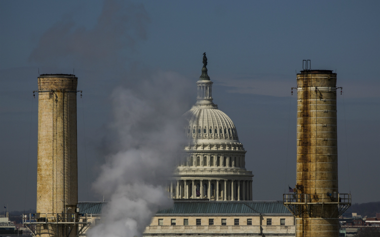 The U.S. Capitol is seen behind a coal-burning power plant in Washington March 10, 2014. (CNS photo/Jim Lo Scalzo, EPA)