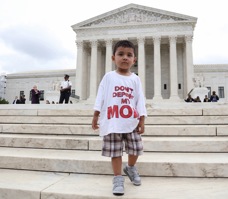 A boy wearing a T-shirt reading "Don't Deport My Mom" stands outside the U.S. Supreme Court in Washington June 23. (CNS photo/Andrew Gombert, EPA) 