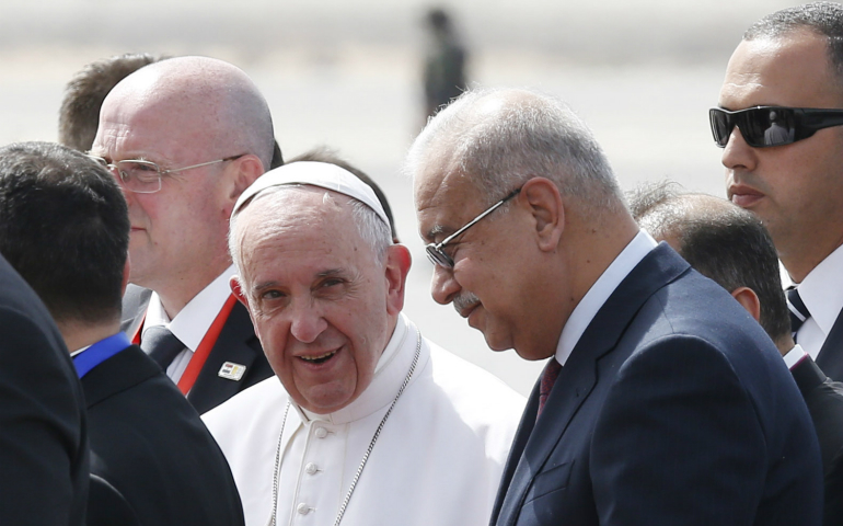 Pope Francis walks with Egyptian Prime Minister Prime Minister Sherif Ismail, right, as he arrives at the international airport in Cairo April 28. The pope was making a two-day visit to Egypt. (CNS photo/Paul Haring)