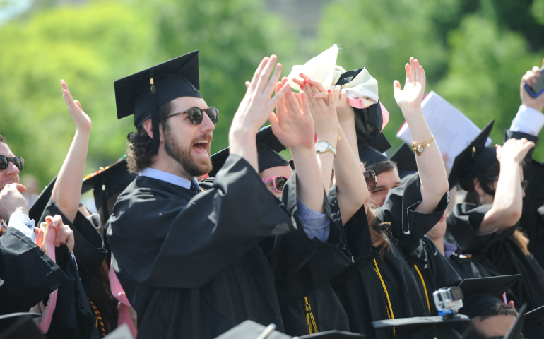 Graduates celebrate during The Catholic University of America's 127th annual commencement May 2016 outside the Basilica of the National Shrine of the Immaculate Conception in Washington. (CNS/Dana Rene Bowler, CUA)