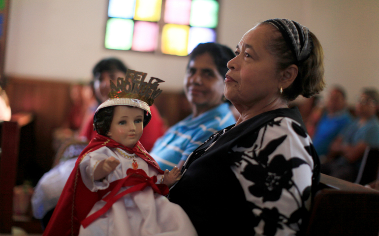 A woman holds a figurine of the Christ Child during a traditional procession celebrating the feast of the Holy Innocents in Antiguo Cuscatlan, El Salvador, Dec. 28, 2016. The event recalls the children massacred in Bethlehem by Herod in his attempt to destroy the child Jesus. (CNS photo/Jose Cabezas, Reuters)
