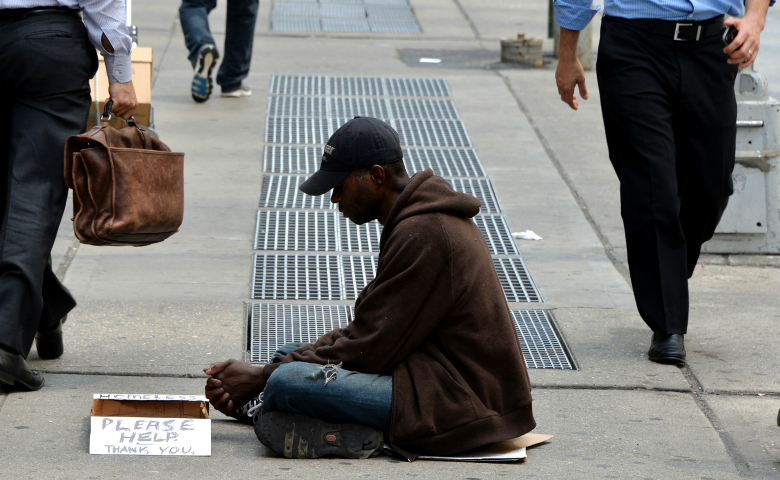 June 16, 2014, file photo, a homeless man sits on a sidewalk in New York City. (CNS photo/Justin Lane, EPA)