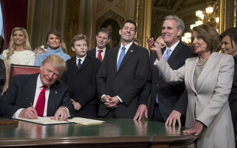 President Donald Trump is joined by the congressional leadership and his family as he formally signs his Cabinet nominations into law Jan. 20 at the U.S. Capitol in Washington. (CNS photo/J. Scott Applewhite, pool via Reuters)