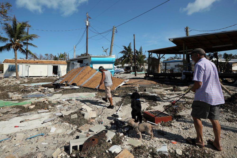 Men walk in a destroyed mobile home park Sept. 12 in the aftermath of Hurricane Irma in the Florida Keys. (CNS/Carlos Barria, Reuters)