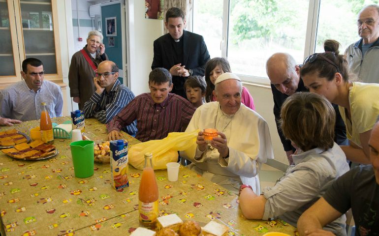 Pope Francis holds a candle as he visits the "Chicco" community, part of the L'Arche movement, in Ciampino, Italy, May 2016. (CNS photo/L'Osservatore Romano)