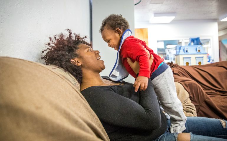A woman plays with her 1-year-old son in late February at Our Lady's Inn maternity home in St. Louis. (CNS photo/Lisa Johnston, St. Louis Review)
