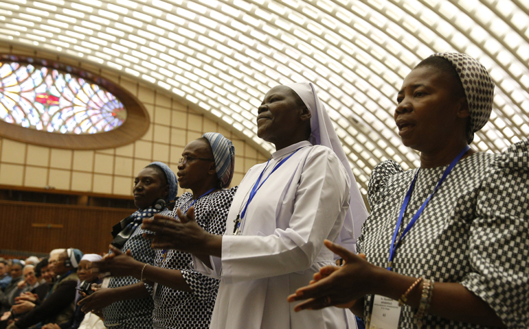 Nuns sing as they wait for Pope Francis' arrival at an audience with the heads of women's religious orders in Paul VI hall at the Vatican May 12. (CNS/Paul Haring)