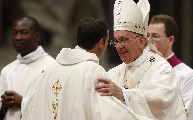 Pope Francis greets a new priest during an ordination Mass in St. Peter's Basilica at the Vatican in April 2015. (CNS photo/Paul Haring) 