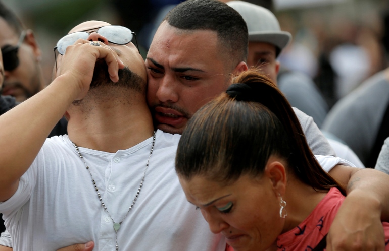 Mourners grieve at a June 13 vigil for the victims of the mass shooting at the Pulse gay nightclub in Orlando, Fla., where a lone gunman killed 49 people early June 12 at the nightclub. (CNS photo/Jim Young, Reuters)