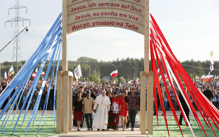 Pope Francis walks with pilgrims through the Door of Mercy as he arrives for a prayer vigil as part of World Youth Day at the Field of Mercy in Krakow, Poland, July 30. (CNS photo/Paul Haring)