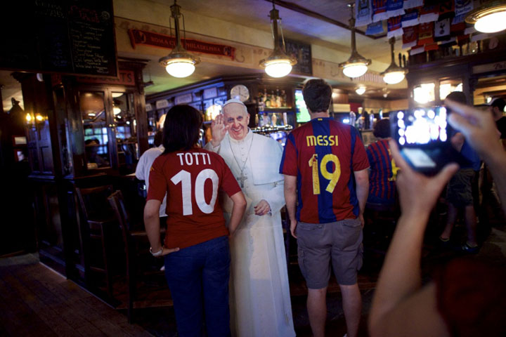 Soccer fans pose for a photo next to a cardboard cutout of Pope Francis at Fado Irish Pub & Restaurant in Philadelphia Sept. 16. (CNS photo/Mark Makela, Reuters)