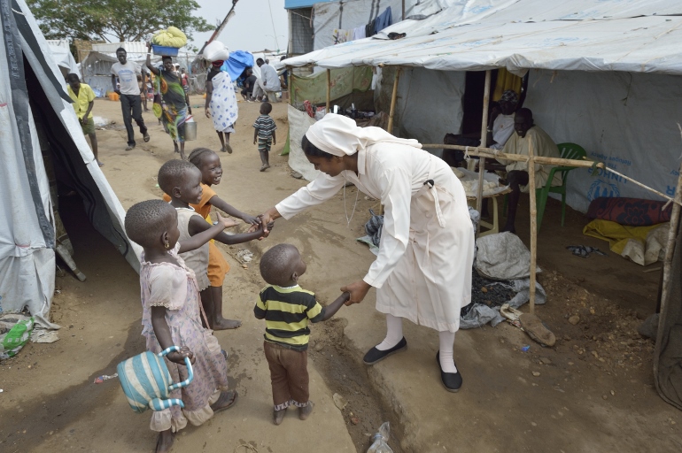 Sr. Amala Francis, a member of the Daughters of Mary Immaculate, greets children inside a United Nations camp for internally displaced families in Juba, South Sudan, April 1. Ten Daughters of Mary Immaculate sisters from India minister to people displa ced by violence between factions in the fledgling country. (CNS photo/Paul Jeffrey) 