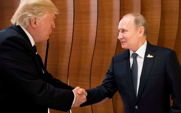 President Donald Trump and Russian President Vladimir Putin shake hands during the Group of 20 meeting in Hamburg, Germany, July, 7. (CNS/Handout via Reuters)