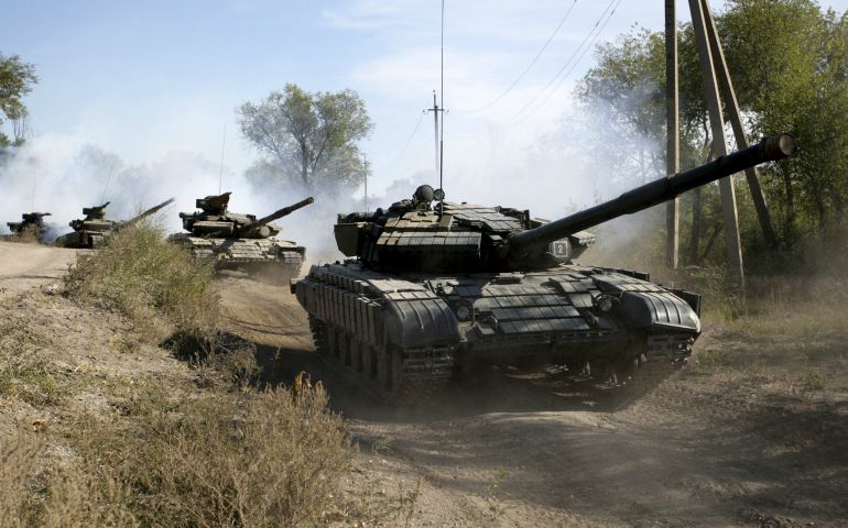 Soldiers of the self-proclaimed Luhansk People's Republic movement ride tanks as they withdraw from the front line outside Luhansk, Ukraine, October 2015. (CNS/Alexander Ermochenko, Reuters)