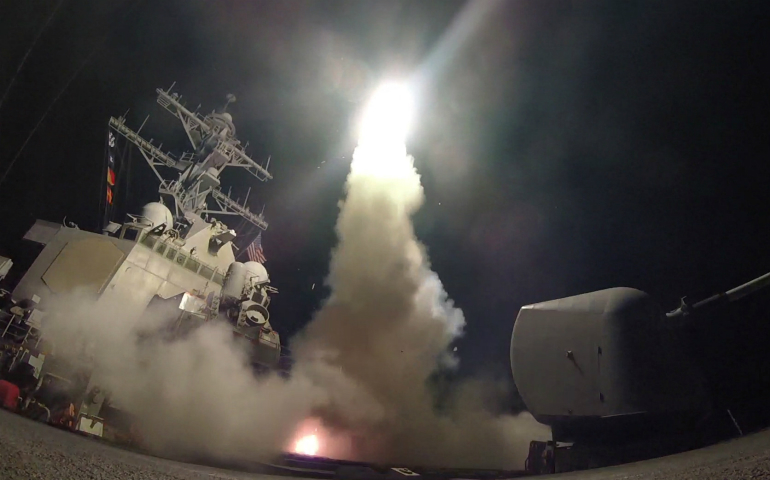 The USS Porter, in the Mediterranean Sea, fires a Tomahawk missile April 7. The missile strike on a Syrian air base days after chemical weapons were dropped on civilians in rebel-controlled territory further endangers innocent people, said observers familiar with the just-war theory. (CNS photo/U.S. Navy handout via Reuters) 