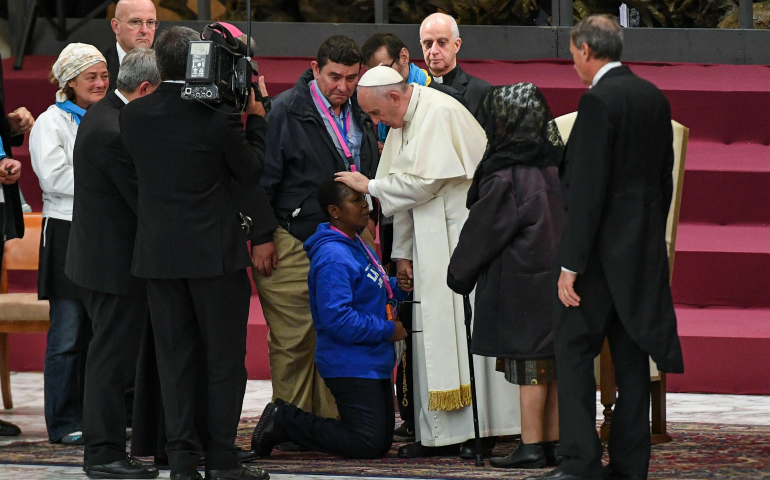 Pope Francis blesses a pilgrim during a special audience with homeless people in Paul VI hall at the Vatican, Nov.11, 2016. (CNS photo/Alessandro Di Meo, EPA)