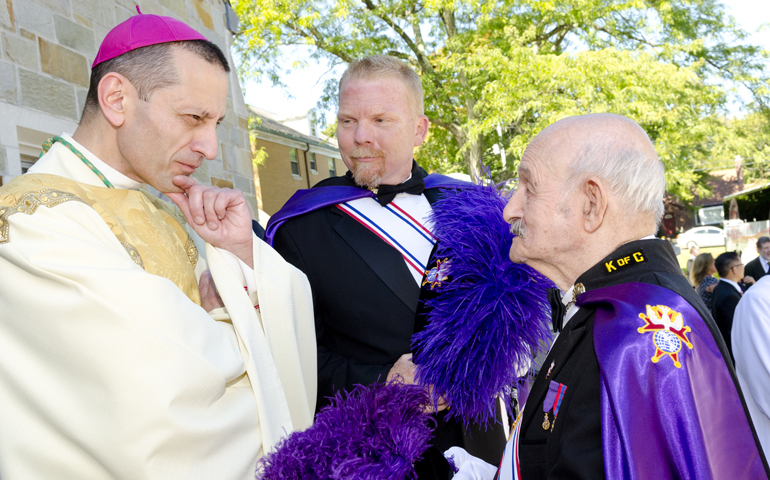 Bishop Frank Caggiano, left, talks with members of the Knights of Columbus following Caggiano's September 2013 installation Mass at St. Theresa Church in Trumbull, Conn. (CNS/Fairfield County Catholic/Amy Mortensen)