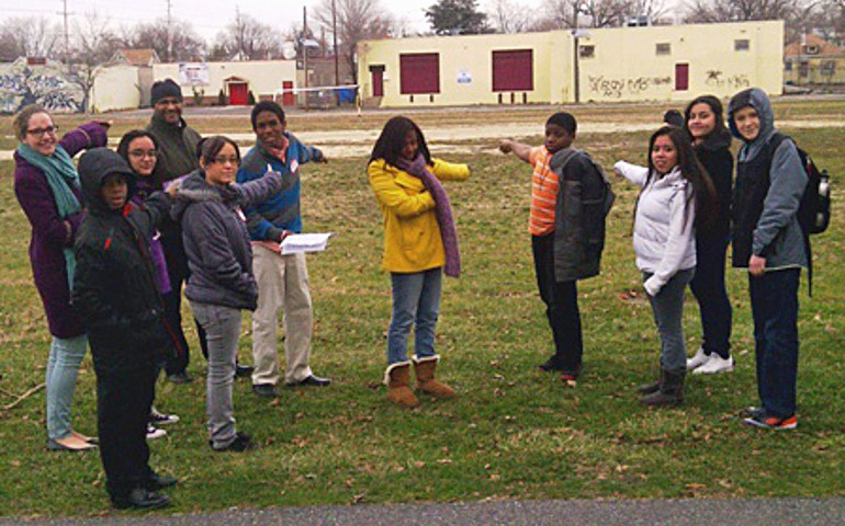 Student leaders, the Rev. Ed Livingston, director of Camden Churches Organized for People, Franciscan volunteer Lauryn Klingler, and participants in the Martin Luther King Day of Community Organizing point out a warehouse by Von Nieda Park that needs graffiti removed. (Student Leaders' Von Nieda Park Task Force)