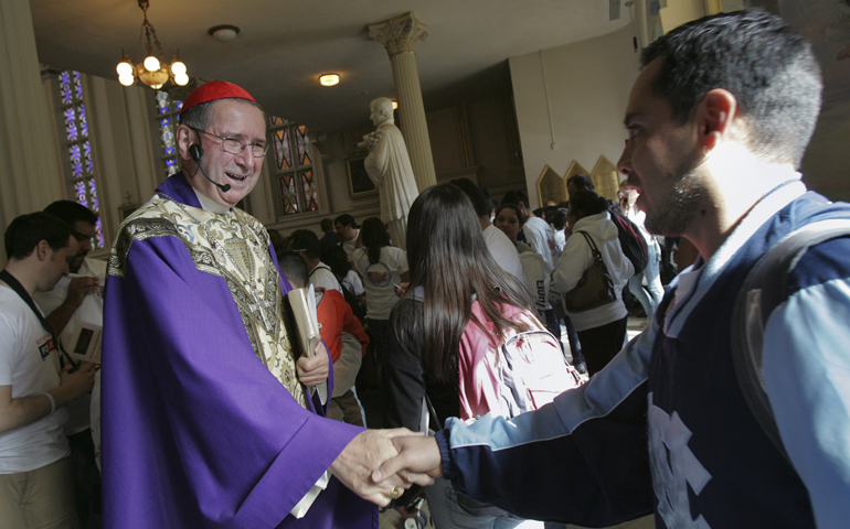 Cardinal Roger Mahony, retired archbishop of Los Angeles, greets people as they arrive for a special Mass for immigrants in Washington in 2010. (CNS/Nancy Phelan Wiechec) 