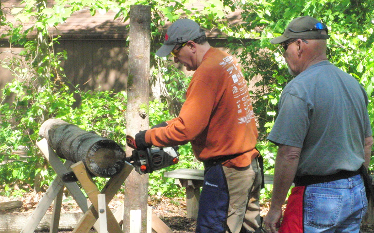 Mike Benton, training instructor (right), supervises a student during St. Ann's Disaster Relief Ministry chainsaw class. (Bob Chaffer/St. Ann's Disaster Relief Ministry)