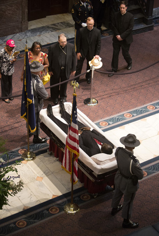 Bishop Robert Guglielmone of Charleston S.C., offers a prayer while paying his respects to the Rev. Clementa Pinckney, a pastor and state senator, Wednesday inside the South Carolina Statehouse in Columbia. (CNS/The Catholic Miscellan/Mic Smith)