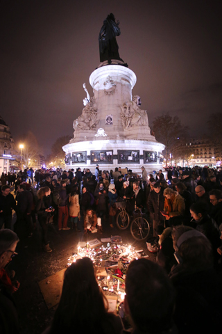 People light candles as they gather Wednesday in Paris to commemorate the victims and condemn the killings at offices of Charlie Hebdo, a satirical newspaper. (CNS/EPA/Fredrik Von Erichsen)