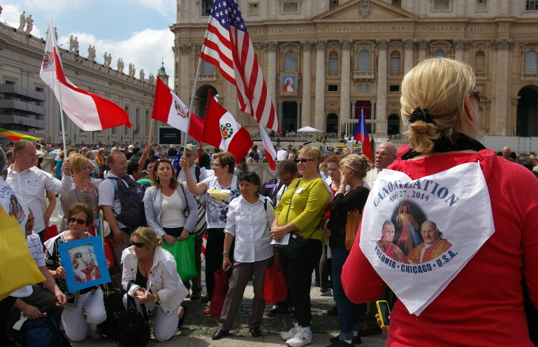 A groups of pilgrims from Chicago of Polish descent gather in St. Peter's Square at the Vatican April 26, a day before the canonizations of Popes John XXIII and John Paul II (NCR photos/Joshua J. McElwee)