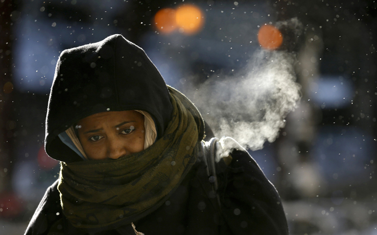 A woman walks in below-zero temperatures Monday though downtown Chicago. (CNS/Reuters/Jim Young)