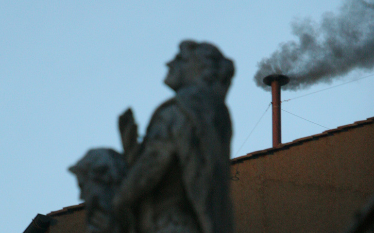Black smoke rises from the chimney of the Sistine Chapel on April 18, 2005, signaling that the cardinals' first vote for a new pope was not conclusive. (CNS/Nancy Wiechec) 