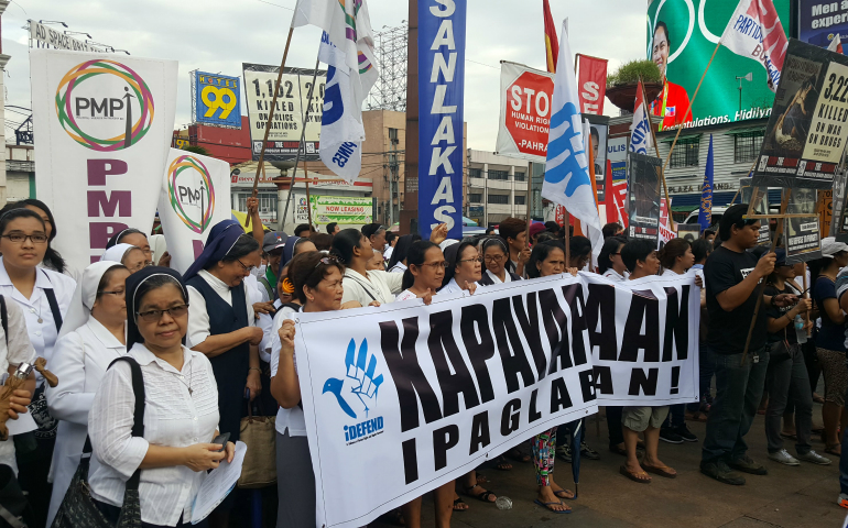 Led by sisters, brothers, seminarians and priests, and joined by human rights and labor organizations, the march wound its way through a historic section of the city to the Plaza Miranda. (GSR photo/Gail DeGeorge)