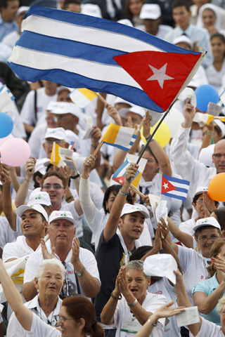A man waves Cuba's flag during the 2012 visit of Pope Benedict XVI to Cuba. (CNS/Paul Haring)