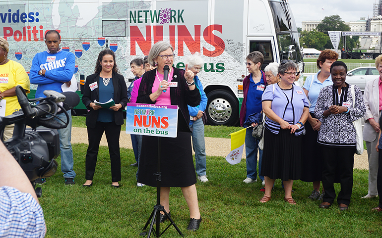 Social Service Sr. Simone Campbell speaks at a 2015 Nuns on the Bus stop in Washington, D.C. (NCR file photo/Vinnie Rotondaro)