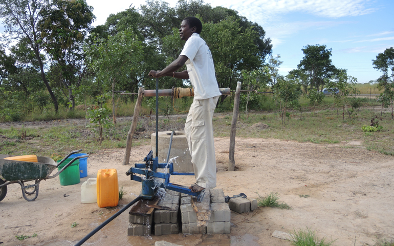 A man pumps water for irrigation and building at the Garden of Oneness in rural Zambia. (Melanie Lidman)